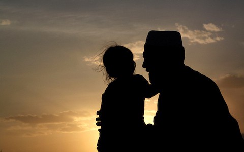 A young man brought her doughter to enjoy the evening together, Herat Afghanistan